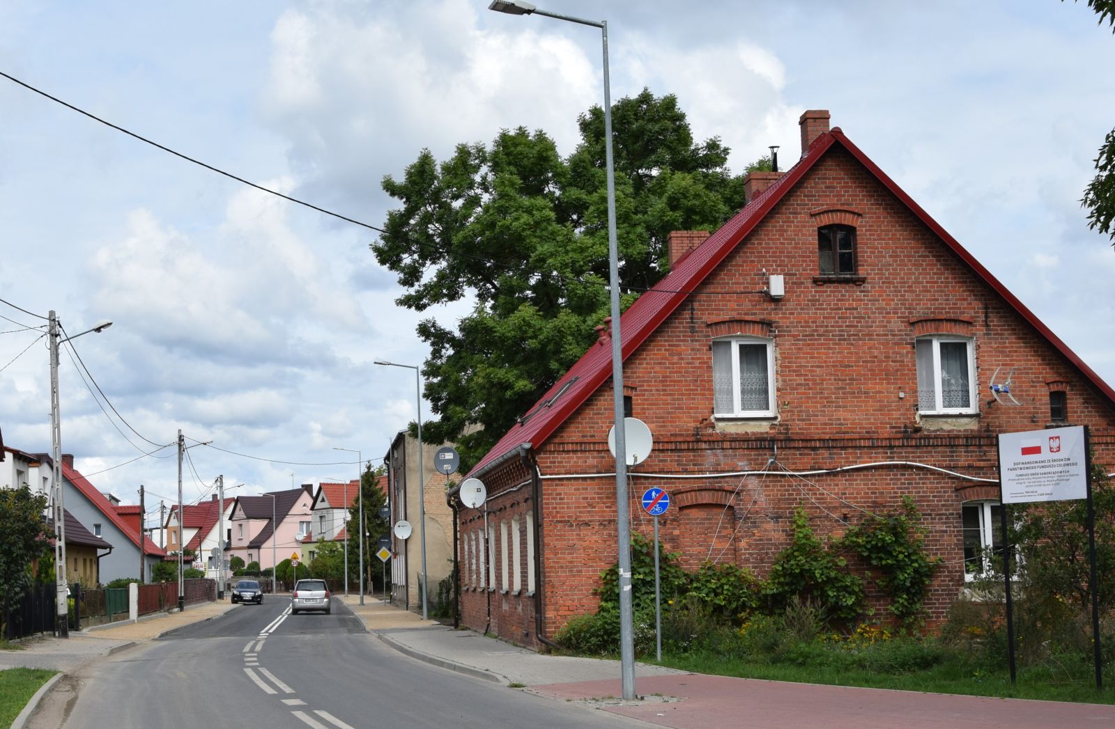 Ulica Wojska Polskiego. Niebo, jezdnia, lampy, domy